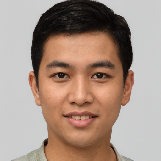 Joyful asian young-adult male with short  brown hair and brown eyes