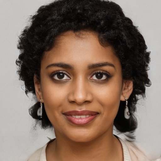 Joyful black young-adult female with medium  black hair and brown eyes