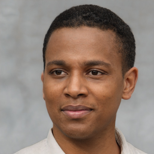 Joyful latino young-adult male with short  brown hair and brown eyes