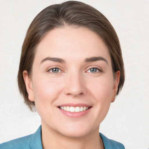 Joyful white young-adult female with medium  brown hair and grey eyes