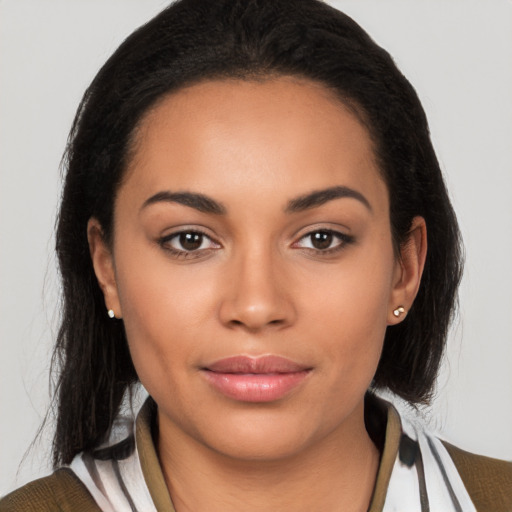 Joyful latino young-adult female with medium  brown hair and brown eyes