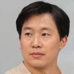 Neutral asian adult male with short  brown hair and brown eyes