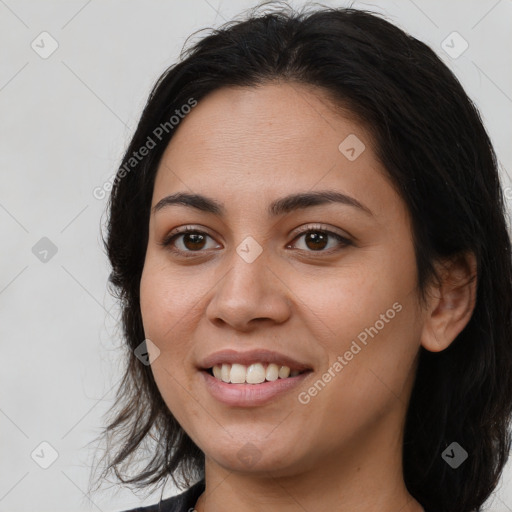 Joyful latino young-adult female with medium  brown hair and brown eyes