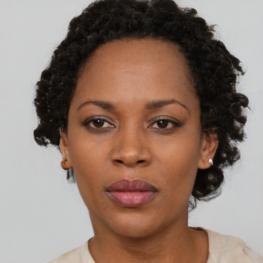 Neutral black adult female with short  black hair and brown eyes