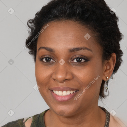 Joyful black young-adult female with short  brown hair and brown eyes