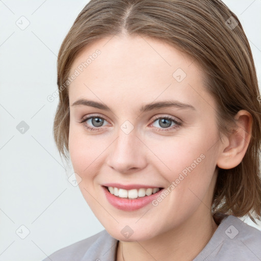 Joyful white young-adult female with medium  brown hair and blue eyes