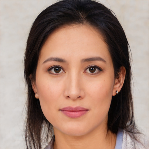 Joyful asian young-adult female with medium  brown hair and brown eyes