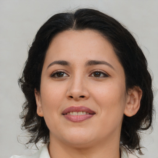 Joyful latino young-adult female with medium  brown hair and brown eyes