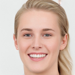 Joyful white young-adult female with long  brown hair and blue eyes