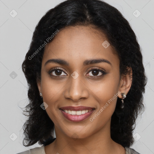 Joyful black young-adult female with long  black hair and brown eyes