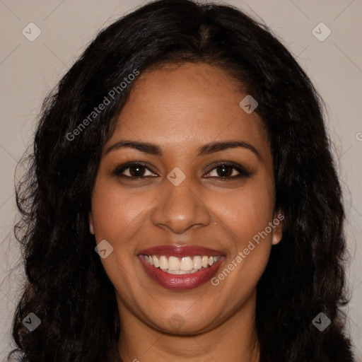 Joyful black young-adult female with long  black hair and brown eyes