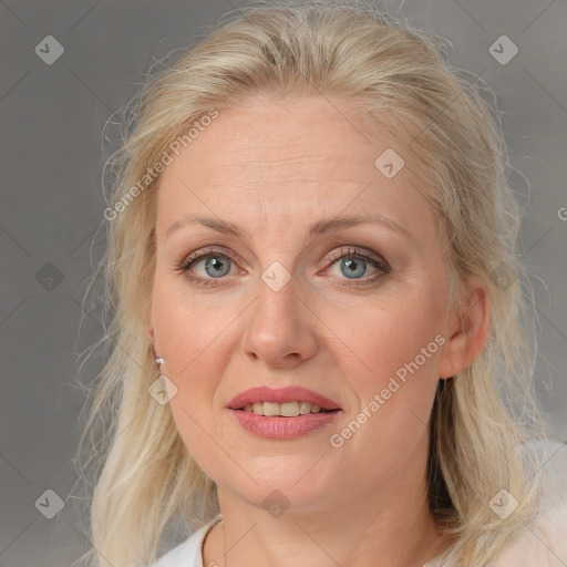 Joyful white adult female with medium  brown hair and blue eyes