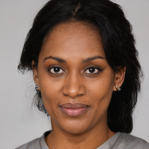 Joyful black young-adult female with medium  black hair and brown eyes