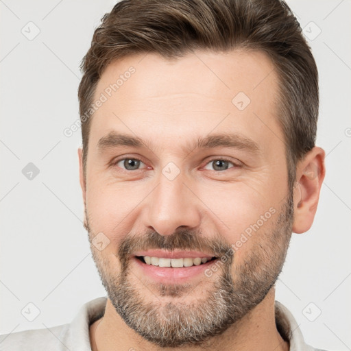 Joyful white adult male with short  brown hair and brown eyes