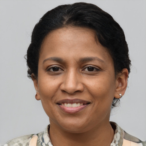 Joyful latino adult female with short  brown hair and brown eyes