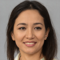 Joyful latino young-adult female with medium  brown hair and brown eyes