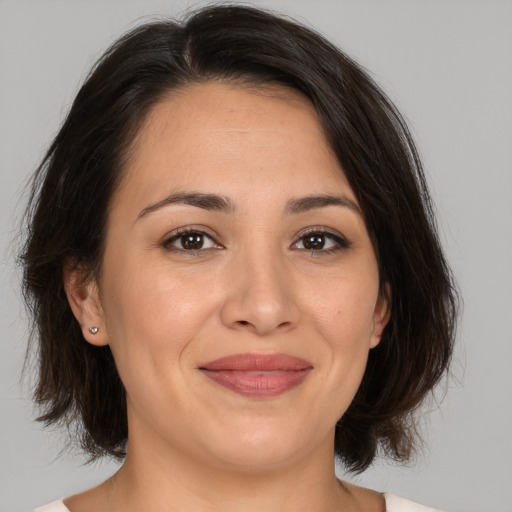 Joyful white adult female with medium  brown hair and brown eyes