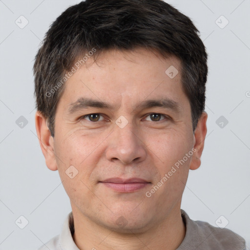 Joyful white adult male with short  brown hair and brown eyes