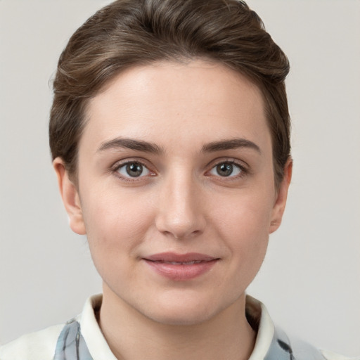 Joyful white young-adult female with short  brown hair and grey eyes