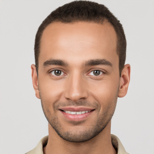 Joyful white young-adult male with short  brown hair and brown eyes