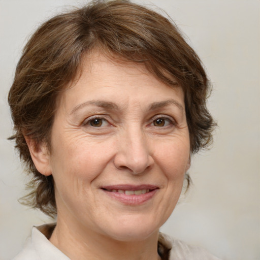 Joyful white middle-aged female with medium  brown hair and brown eyes