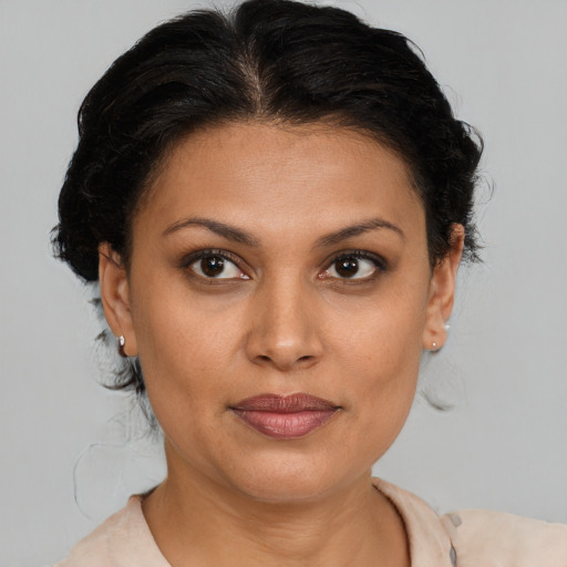 Joyful latino young-adult female with short  brown hair and brown eyes