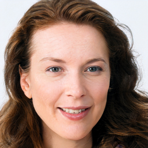 Joyful white young-adult female with long  brown hair and blue eyes