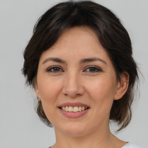 Joyful asian adult female with medium  brown hair and brown eyes