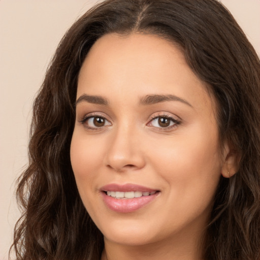 Joyful white young-adult female with long  brown hair and brown eyes