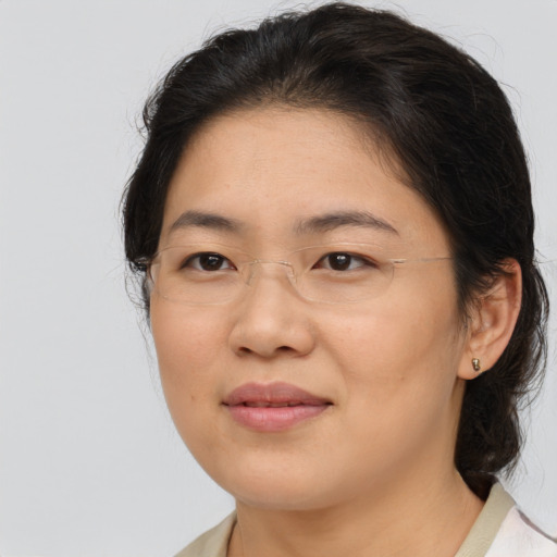 Joyful white adult female with medium  brown hair and brown eyes