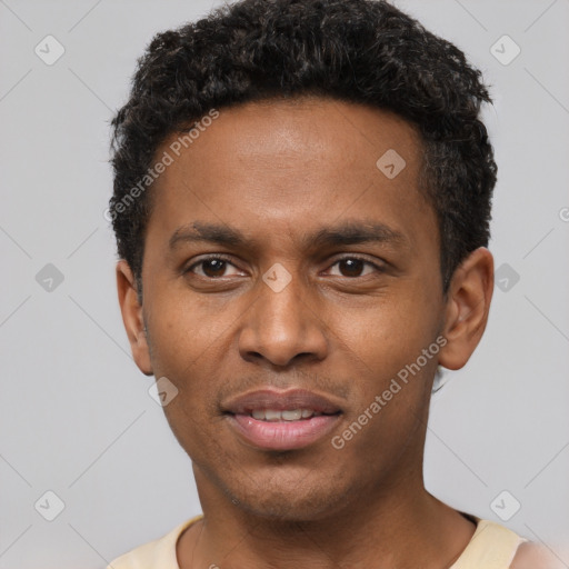 Joyful black young-adult male with short  brown hair and brown eyes