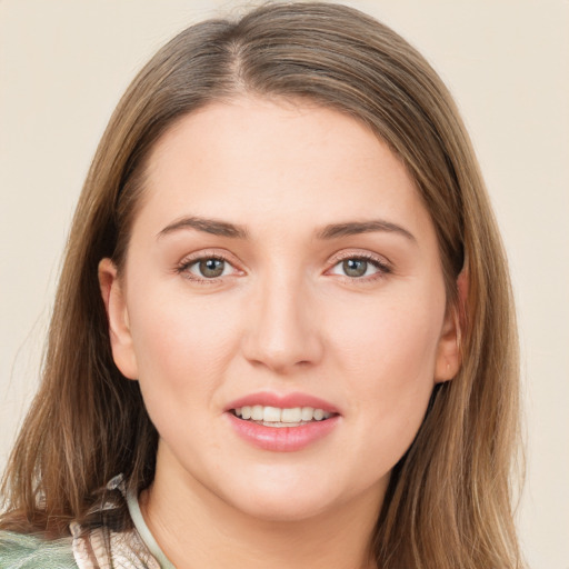 Joyful white young-adult female with medium  brown hair and green eyes