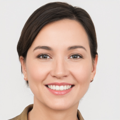 Joyful white young-adult female with medium  brown hair and brown eyes