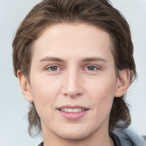 Joyful white young-adult female with medium  brown hair and grey eyes