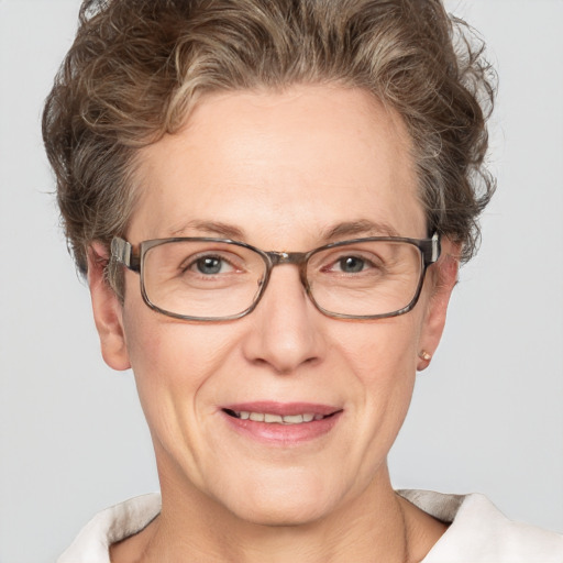 Joyful white middle-aged female with short  brown hair and grey eyes