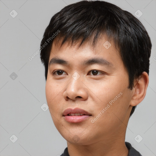 Joyful asian young-adult male with short  black hair and brown eyes