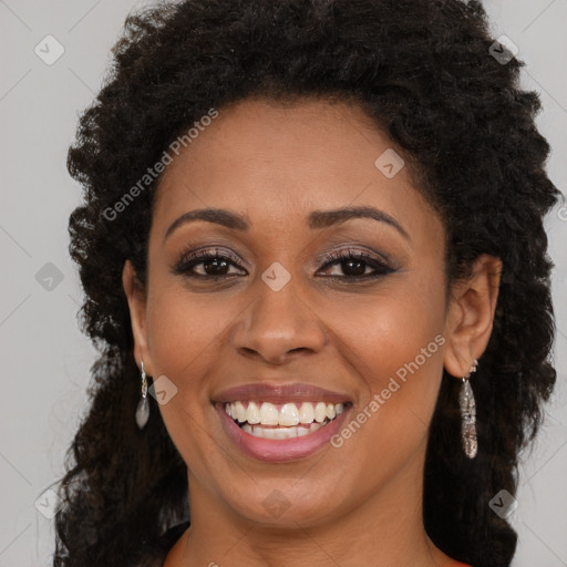 Joyful black young-adult female with long  brown hair and brown eyes