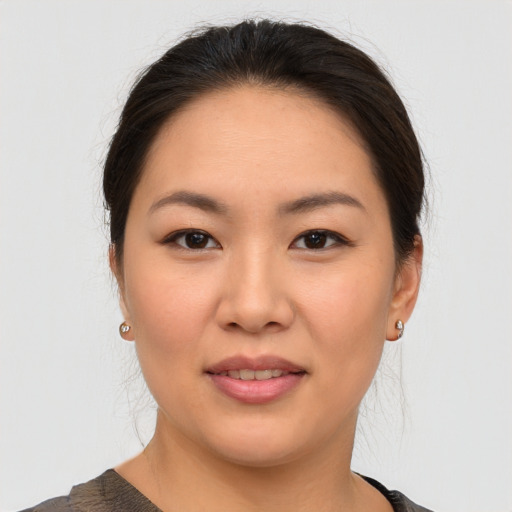 Joyful asian young-adult female with medium  brown hair and brown eyes