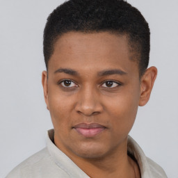 Joyful black young-adult male with short  black hair and brown eyes