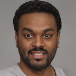 Joyful black young-adult male with short  black hair and brown eyes