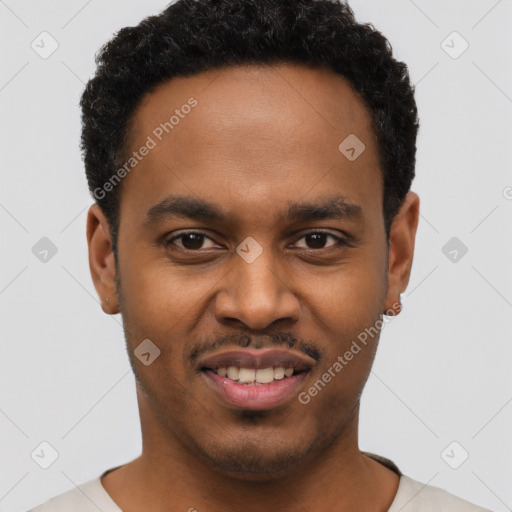 Joyful black young-adult male with short  black hair and brown eyes