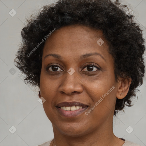 Joyful black adult female with short  brown hair and brown eyes