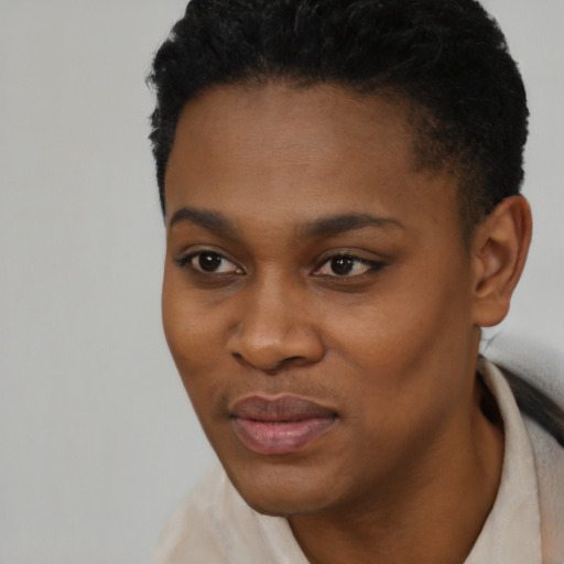 Joyful black young-adult female with short  black hair and brown eyes