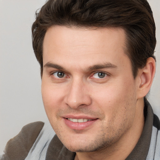 Joyful white adult male with short  brown hair and brown eyes