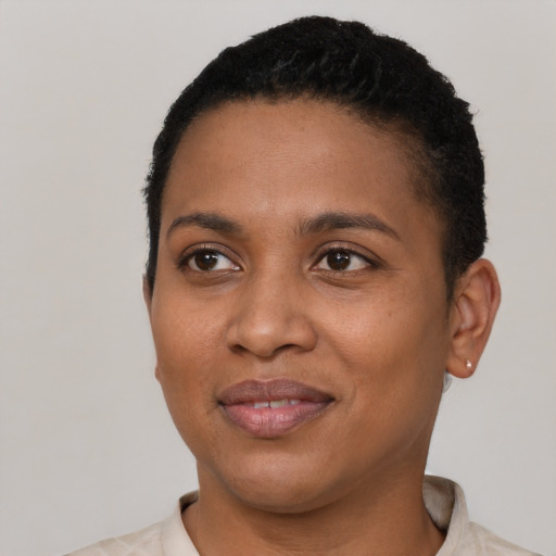 Joyful black young-adult female with short  black hair and brown eyes
