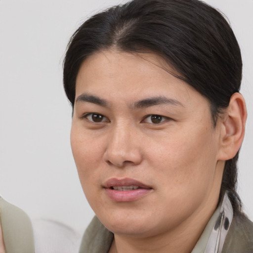 Joyful asian young-adult female with medium  brown hair and brown eyes