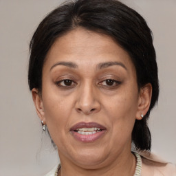 Joyful white adult female with medium  brown hair and brown eyes