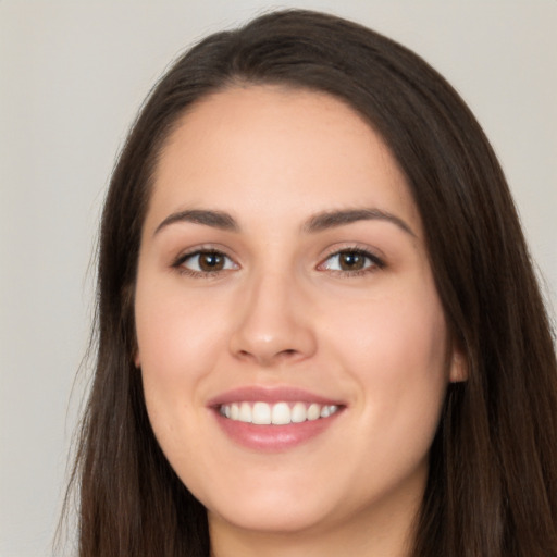 Joyful white young-adult female with long  brown hair and brown eyes