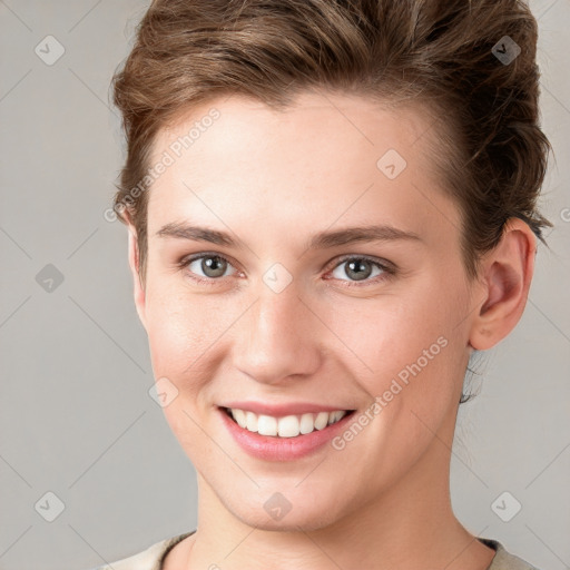 Joyful white young-adult female with short  brown hair and grey eyes