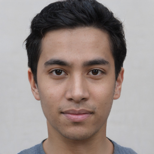 Joyful asian young-adult male with short  black hair and brown eyes